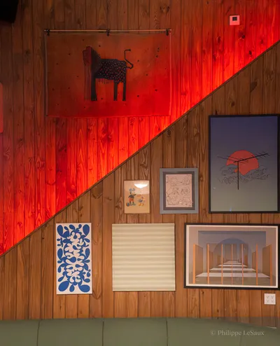 Carefully curated art against an illumincated staircase