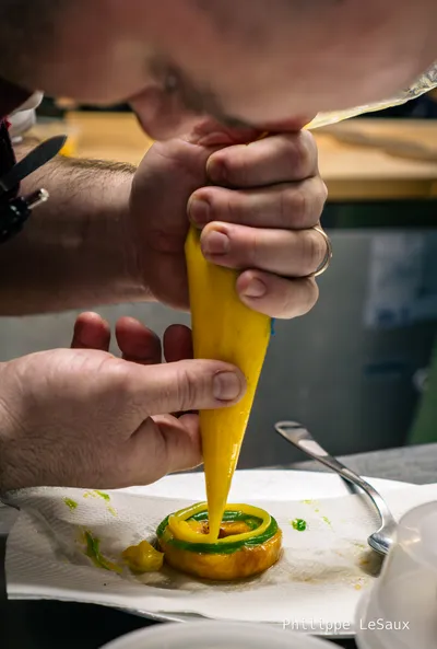 Chef Chris D'Ambro decorates a peach doughnut